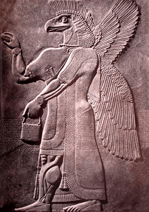 Ancient relief depicting a winged figure with a bird-like head and a human body, holding a bucket.